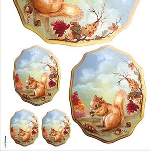 May include: Four oval-shaped, decorative plates with a gold trim. Each plate features a painting of a squirrel holding an acorn in a forest setting with autumn leaves. The plates are different sizes.
