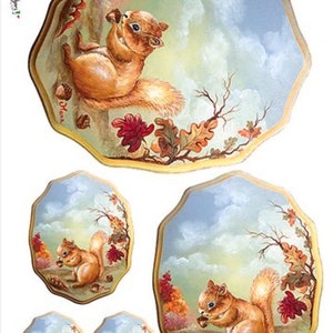 May include: Set of four painted ceramic plates featuring a squirrel holding an acorn in a woodland setting with autumn leaves and a blue sky. The plates are different sizes and have a gold rim.