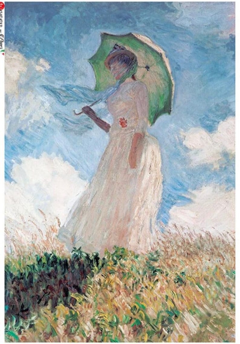 May include: A woman in a white dress and a green hat holds a green umbrella while walking through a field of tall grass. The sky is blue with white clouds.