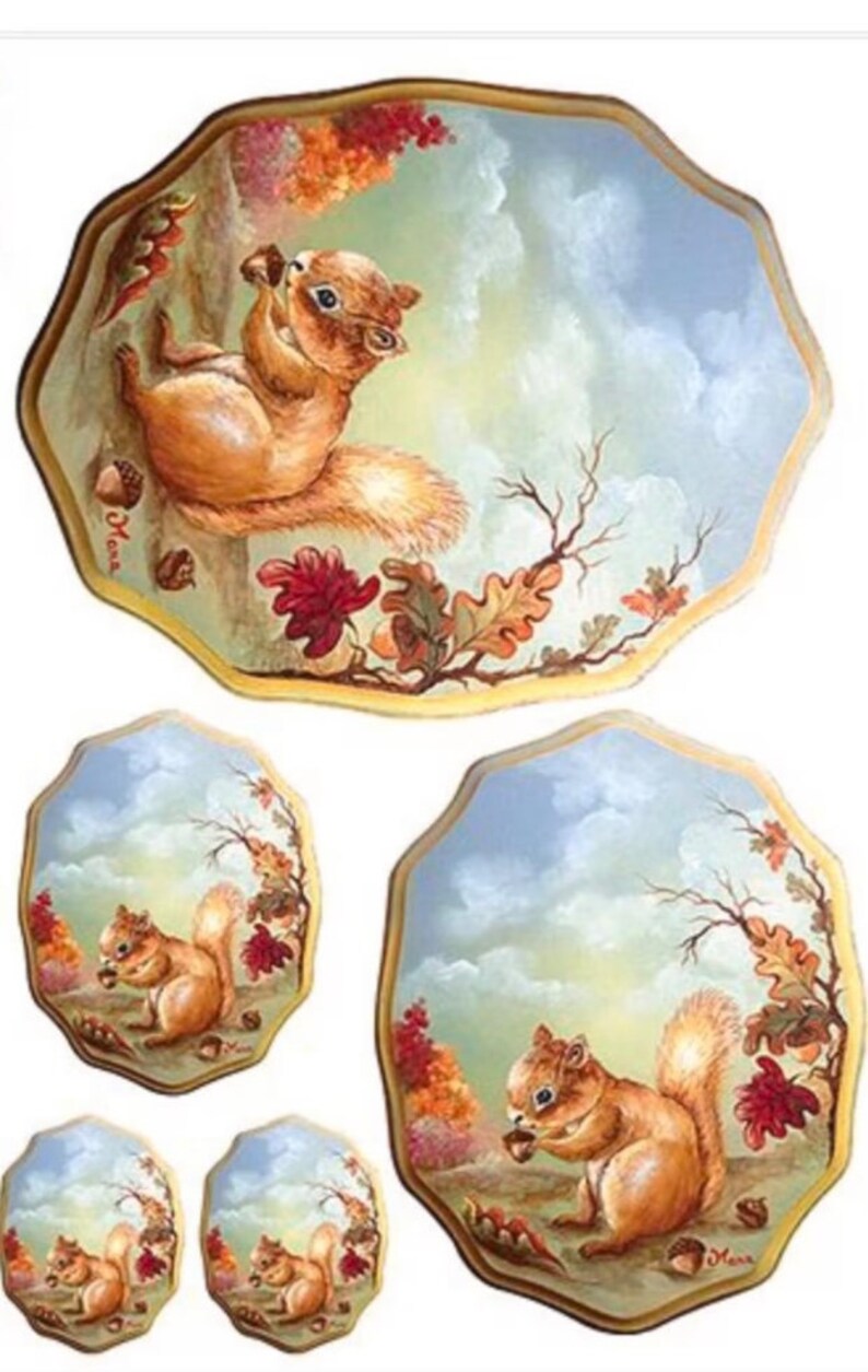 May include: Set of four decorative ceramic plates featuring a squirrel holding an acorn in a woodland setting. The plates are painted with a blue sky, brown branches, and green leaves. The squirrel is brown with a bushy tail.