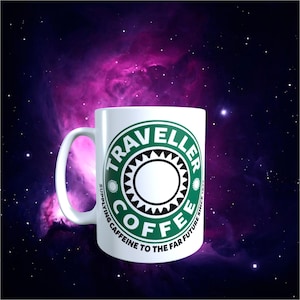 May include: White ceramic coffee mug with a green and black logo that reads "Traveller Coffee" with the text "Supplying Caffeine to the Far Future Since 1973". The mug has a white handle and is set against a space-themed background.