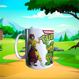 May include: White ceramic mug featuring Teenage Mutant Ninja Turtles characters and logo. The mug showcases April O'Neil, Splinter, and two of the turtles in vibrant colors. The mug has a curved handle and is set against a cartoon landscape.