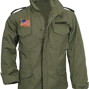May include: Olive green military-style jacket with multiple pockets and a high collar. Features a U.S. Army patch and an American flag patch on the chest. The jacket has a zipper closure and buttoned cuffs.