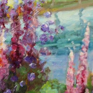 May include: A painting of purple and pink flowers with green leaves in front of a blue and green water background.