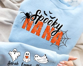 May include: Pale blue sweatshirt with the text "Spooky Nana" in black and orange, decorated with a spider, bats, and a spiderweb. The sleeve shows three ghost illustrations with the names "Sarah", "Emma", and "Alex".