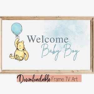 May include: A framed print with the words "Welcome Baby Boy" in gray and teal script. A cartoon bear holds a blue balloon. The words "Downloadable Frame TV Art" are at the bottom.