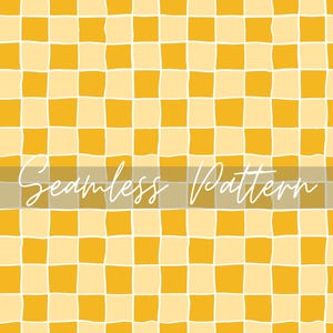 May include: Seamless pattern featuring a grid of yellow and cream-colored squares. The squares have a slightly irregular, hand-drawn appearance, with white lines separating them. The words "Seamless Pattern" are written in a cursive font across the center.