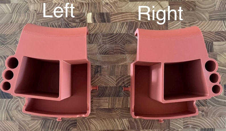May include: Two coral-colored plastic organizers, labeled "Left" and "Right", are displayed. Each organizer has a rectangular compartment, a smaller square compartment, and three circular holes. The organizers are designed to hold various items.