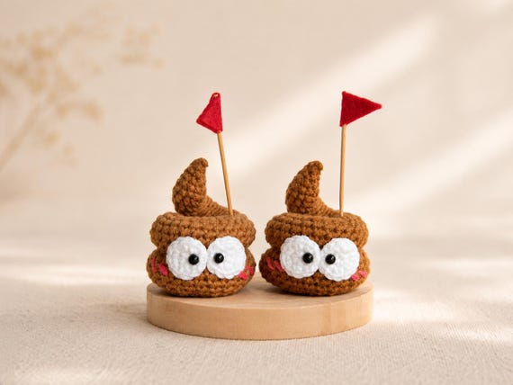 A hand-crocheted amigurumi poop emoji that somehow manages to be genuinely charming — the craft skill and tactile silliness make it a standout gag desk companion.