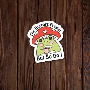 The Horrors Persist But So Do I Vinyl Sticker | Funny Frog Coffee Anxiety Decal | Sarcastic Chaos Coordinator Sticker for Laptop, Notebook