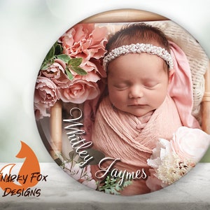 May include: A close-up of a sleeping baby girl wearing a pink headband with pearls and wrapped in a pink blanket. The baby is surrounded by pink flowers and the text "Whitley Jaymes" is written on the image.