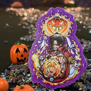 May include: A die-cut sticker featuring a dark-haired character with a tattoo reading ASCE on their arm, surrounded by purple flames and three white ghost-like figures. The character holds a glowing orange jack-o'-lantern with another above.