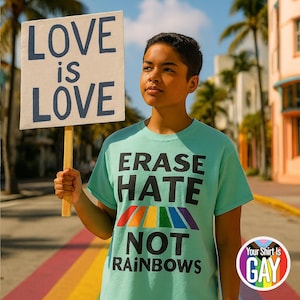 May include: A person holding a sign that reads "LOVE is LOVE". They are wearing a light green t-shirt with the text "ERASE HATE NOT RAINBOWS" and a rainbow design. The image also includes a logo that says "Your Shirt Is GAY".