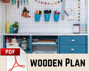 May include: A blue wooden craft desk with a pegboard back, featuring various craft supplies. The desk has drawers and shelves. The image includes the text "PDF" and "WOODEN PLAN".