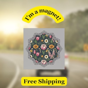 May include: A floral magnet with a dark background, featuring pink tulips, yellow daisies, and other flowers. The magnet has a decorative border and the text "I'm a magnet!" in a yellow banner.