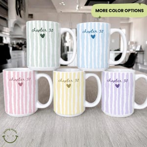 May include: Six ceramic mugs with white handles, each featuring a vertical striped pattern in pastel colors: green, blue, pink, yellow, and purple. The text "chapter 30" and a heart are printed on each mug. The phrase "MORE COLOR OPTIONS" is also visible.