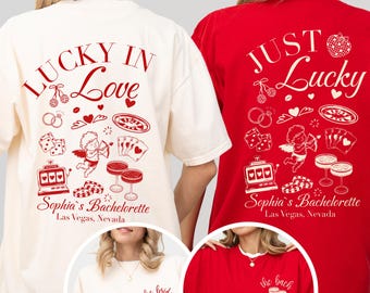 May include: Two oversized t-shirts, one cream and one red, with matching graphics. The cream shirt says "Lucky in Love" and the red shirt says "Just Lucky." Both shirts feature casino-themed illustrations and text for a bachelorette party.
