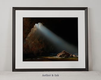 May include: Framed art print featuring a dramatic coastal cave scene. The image captures a beam of light illuminating the cave's interior, highlighting the rock formations and water. The artwork is framed in a black frame with a white mat, and the text "Aether & Ink" is at the bottom.