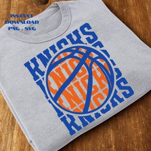 May include: A gray t-shirt featuring a basketball design. The word "Knicks" is printed in blue around a basketball graphic in orange and blue. The text "INSTANT DOWNLOAD PNG . SVG" is printed in blue.