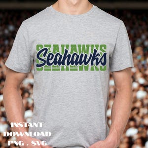 May include: A gray t-shirt with the word "Seahawks" in a green and navy blue design across the chest. The text "Instant Download PNG SVG" is at the bottom of the image.
