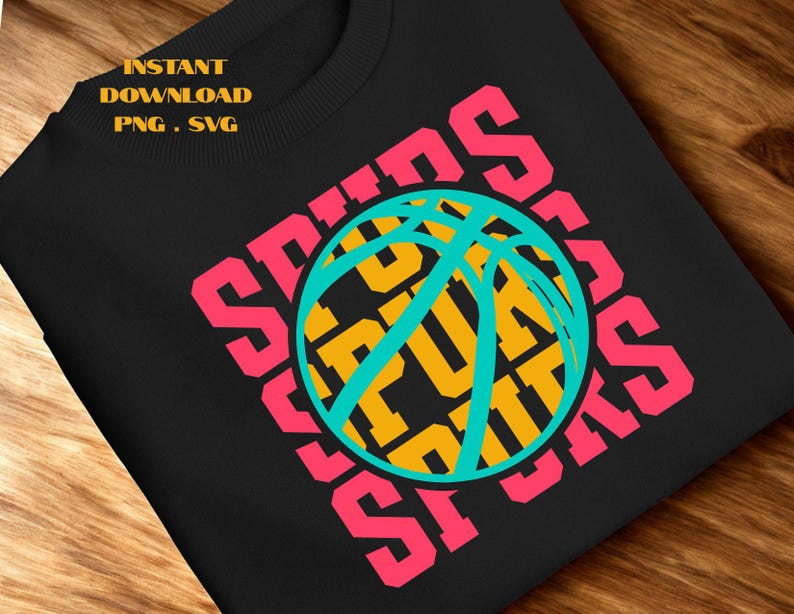May include: Black sweatshirt with a basketball graphic. The word "SPURS" is in pink, surrounding a teal and yellow basketball. The text "INSTANT DOWNLOAD PNG . SVG" is in the upper left corner.