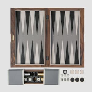 May include: A wooden backgammon set with a dark brown frame and a playing surface featuring alternating black, white, and gray triangles. The set includes dice, checkers, and a storage compartment. The game board is closed and ready for play.