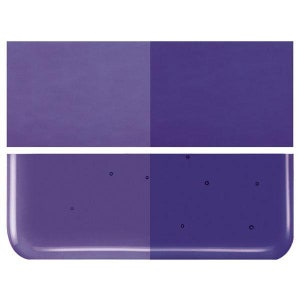 May include: Two purple glass tiles, one with a smooth surface and the other with a textured surface. The textured tile has small air bubbles.
