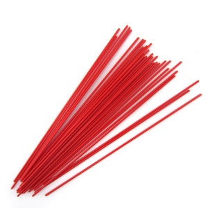 May include: A bundle of bright red craft wire sticks. The wire is thin and flexible, perfect for crafting projects.
