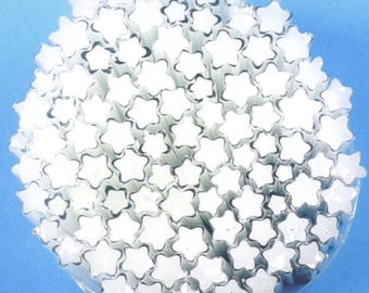 May include: A large collection of white, star-shaped rods bundled together in a circular arrangement. Each individual rod features a distinct five-pointed star profile, creating a dense, uniform cluster of white shapes against a blue background.