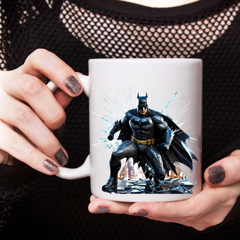 May include: White ceramic mug featuring a detailed illustration of Batman in a dynamic pose. The superhero is depicted in his iconic black and gray suit, with a yellow utility belt. The background includes shattered glass and a cityscape.