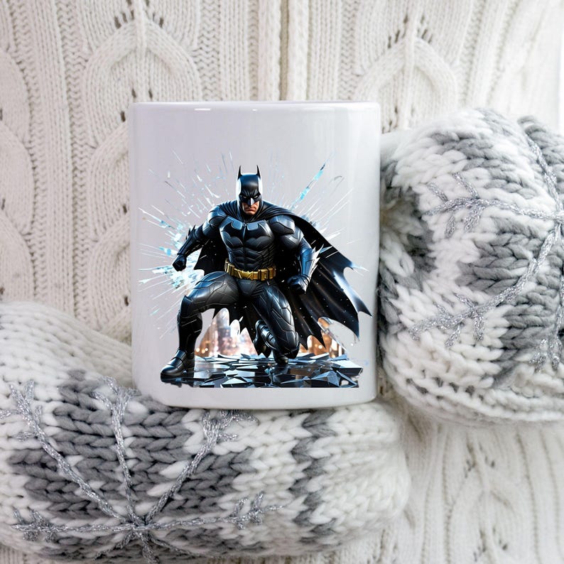 May include: White ceramic mug featuring a detailed illustration of Batman in a dynamic pose. The superhero is depicted in his iconic black and gray suit with a yellow utility belt. The background includes shattered glass and a cityscape.