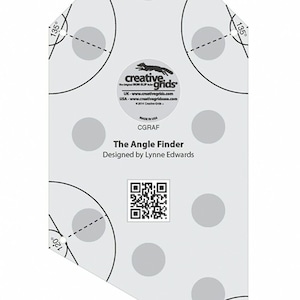 May include: A white plastic angle finder tool with a black fox logo and the text "Creative Grids" and "The Angle Finder" designed by Lynne Edwards. The tool has a series of circles with degree markings, including 90, 135, 120, and 60 degrees.