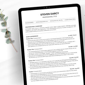 May include: A digital resume template displayed on a tablet. The resume includes sections for professional overview, work experience, and contact information. The text is black on a white background, with the words "Resume Template" in the upper right corner.
