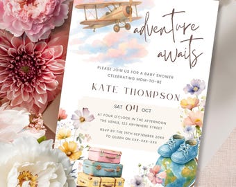 May include: Baby shower invitation with watercolor illustrations. Features a vintage airplane, stacked suitcases, baby shoes, and a globe. The text reads "adventure awaits" and includes event details.