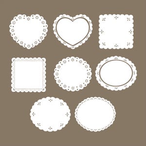 May include: A collection of white paper doilies in various shapes, including hearts, squares, circles, and ovals. Each doily features a delicate, scalloped edge and intricate floral cut-out designs. The background is a solid, muted brown.