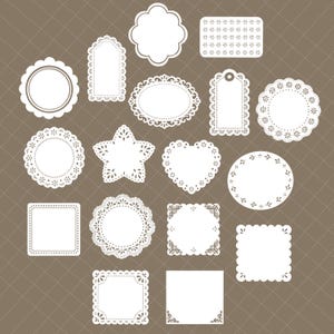 May include: A collection of white paper doilies in various shapes, including circles, squares, ovals, and a star. The doilies have decorative edges and intricate cut-out patterns. The background is a brown grid pattern.