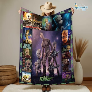 May include: A plush blanket featuring various images of Baby Groot and Groot from the Guardians of the Galaxy movies. The blanket has a purple border with the words "I AM GROOT" and "Baby Groot" printed on it. The central image shows Groot and Baby Groot.