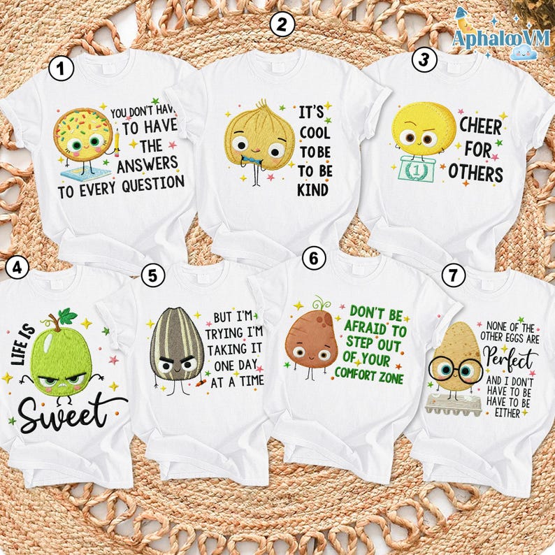 a collection of seven white t-shirts with various cartoon characters and motivational messages printed on them.