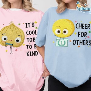two people wearing t-shirts with cartoon characters and text printed on them.