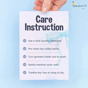 May include: A white card with "Care Instruction" in large, dark blue letters. The card lists laundry instructions: use mild detergent, pre-treat stains, turn garment inside-out, gentle cold cycle, and tumble dry low or hang.
