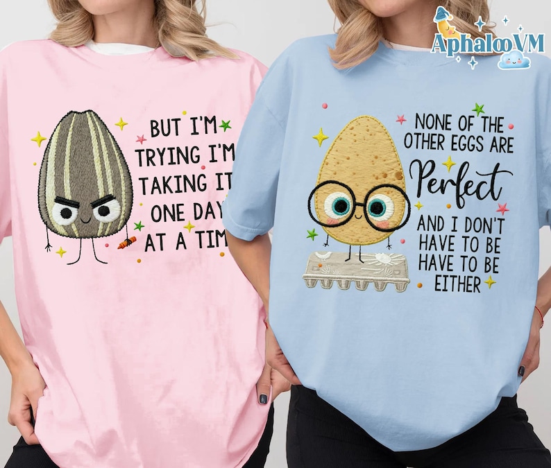 two people wearing t-shirts with humorous text and cartoon characters.