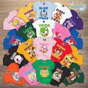 May include: A collection of twenty colorful t-shirts featuring various characters from the Super Mario video game series. Each shirt displays a different character's name and image, including Mario, Luigi, Peach, and Bowser. The shirts come in a variety of colors.