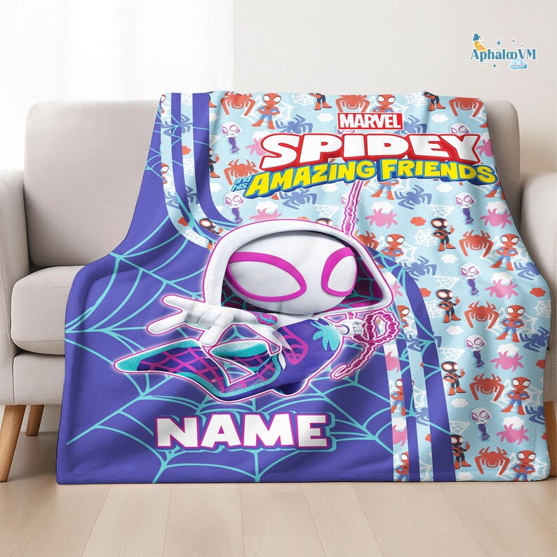 May include: A Spidey and His Amazing Friends blanket featuring a large graphic of Spider-Gwen in a web design. The blanket has a light blue background with repeating spider and character designs. The word "NAME" is displayed.
