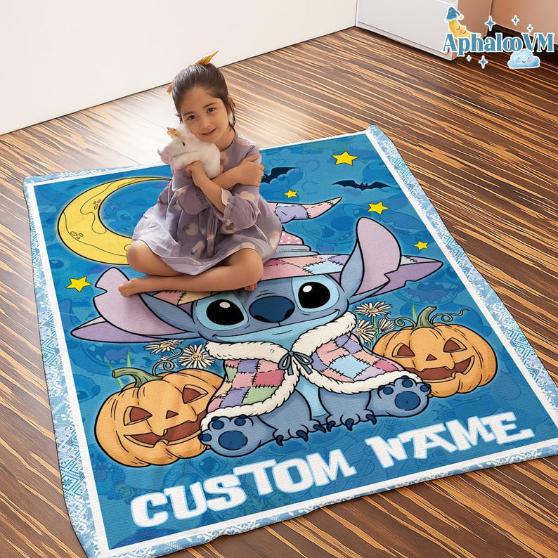 May include: A blue blanket featuring a cartoon character with a witch hat, pumpkins, and the text "CUSTOM NAME". The blanket has a light blue border and a design of stars, bats, and a crescent moon.