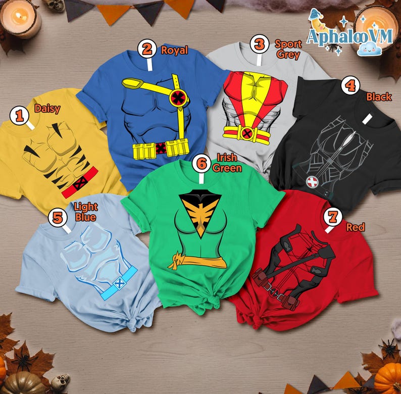 May include: A collection of seven t-shirts in various colors, each featuring a superhero costume design. Colors include yellow, blue, gray, black, light blue, green, and red. The shirts are displayed on a wooden surface.