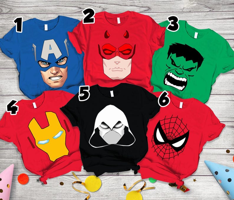 May include: Six short-sleeved t-shirts featuring superhero graphics. Shirt 1 is blue with Captain America, 2 is red with Daredevil, 3 is green with Hulk, 4 is red with Iron Man, 5 is black with Moon Knight, and 6 is red with Spider-Man.