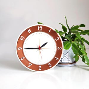 Mid Century Lux Electric Wall Clock with faux copper ring and starburst center