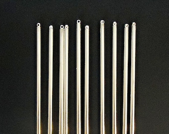 May include: A set of ten silver-colored metal rods with rounded ends. The rods are arranged in a row on a black background.