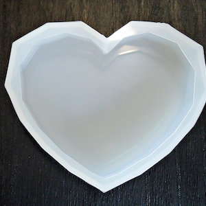 May include: A white heart-shaped silicone mold for making crafts or soap.