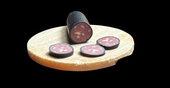 Dollhouse half a raw (pre-cooked) black pudding with slices 1/6 scale by Wyrdworldminiatures